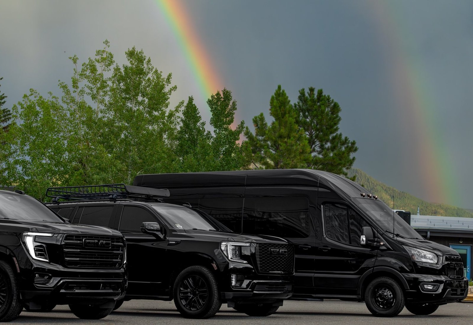 Black GMC Yukon XL with rear doors open, loading for a wedding party